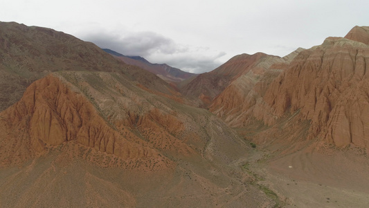 红峡谷吉尔吉斯斯坦鸟瞰图无人机侧身飞行建立镜头视频