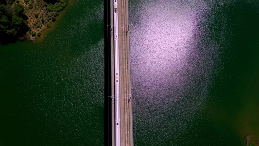 高铁动车列车高铁经过南方山谷上的湖面视频