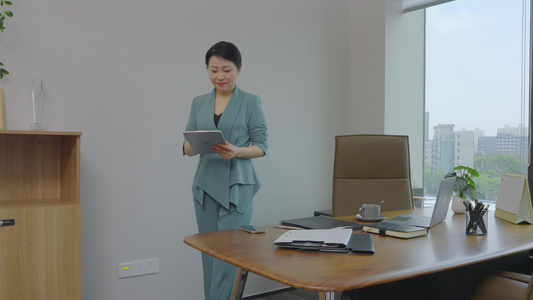 商务女老板在办公室使用平板沟通工作视频