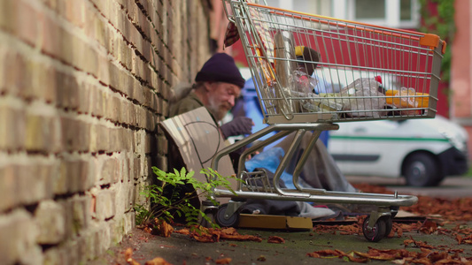 一个无家可归的人在街上吃饭的景象视频
