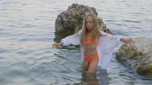 年轻女孩在夏天海滩的海水中12秒视频