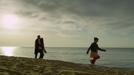 快乐的家庭步行海岸日落海滩视频