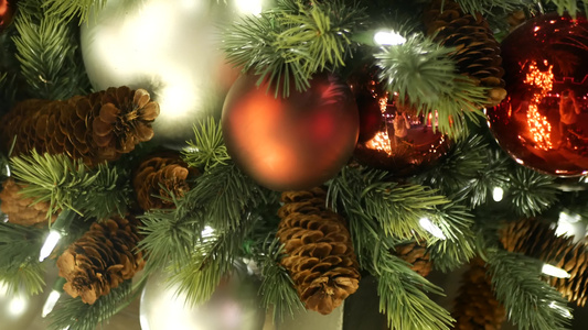 节日装饰的户外圣诞树特写镜头与明亮的红色球模糊闪闪发光视频
