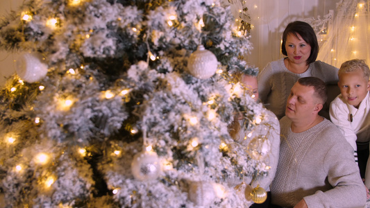 在节日前夕美丽的圣诞树上舒适的客厅里幸福的家庭视频
