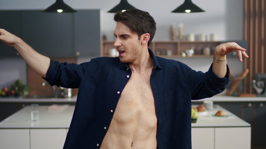 性感男人在现代厨房跳舞的肖像视频