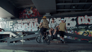 运动型男子在带涂鸦的滑板公园用越野自行车表演跳跃技巧17秒视频