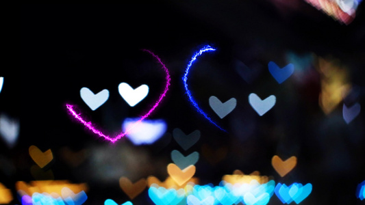 模糊和bokeh心脏塑造爱的情人节色彩多彩的夜光和视频