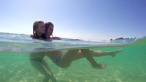 紧贴着少女朋友在度假时拥抱彼此的肖像在海松绿水中喷溅30秒视频