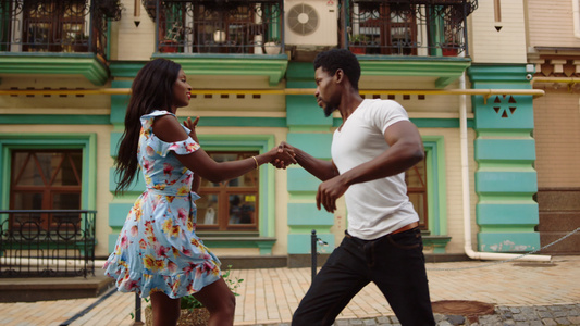 严重的非洲男孩控制女在城里跳舞 一对夫妇在户外跳舞视频