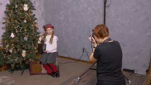 摄影摄影师拍照年轻女孩与灯笼在圣诞节树底背景上13秒视频