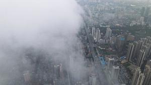 航拍风光城市高空云层之上俯瞰城市建筑道路交通天际线城市素材65秒视频