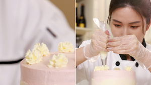 蛋糕师在蛋糕顶上挤奶油花装饰24秒视频
