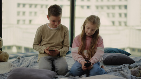 儿童坐在地板上玩游戏视频