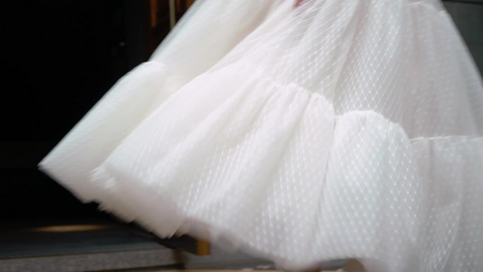 穿着婚纱的年轻新娘在城市里盘旋白色豪华礼服时装视频