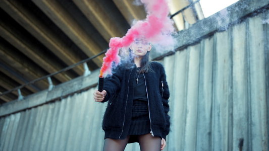 年轻女子用彩色烟对着镜头视频