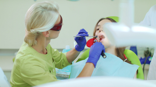 牙科医生在口腔内使用聚合灯视频