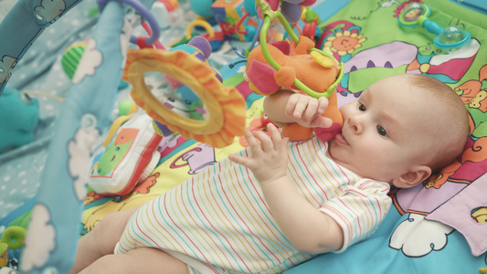 婴儿在多彩的垫子上玩耍视频