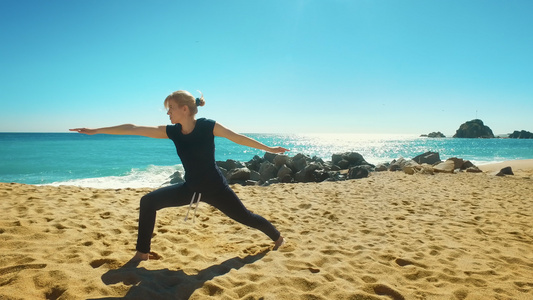 女性在海边做平衡瑜伽视频
