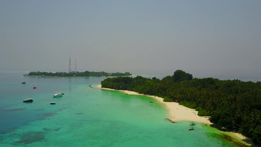 利用蓝水和白沙背景的蓝水对热带海滨海滩度假进行空中视频