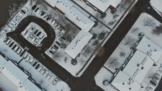 在寒冷的城市街道上飞过雪盖满了房子的冰雪视频