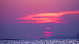 日落和紫色的云在天空中飘过海面表54秒视频