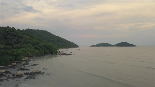 日落时飞越沿海岩石上空的空中飞行视频