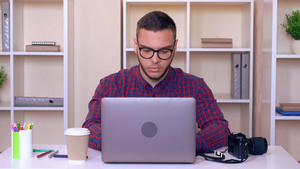 使用笔记本电脑坐在工作场所的男子穿着光亮衬衫17秒视频