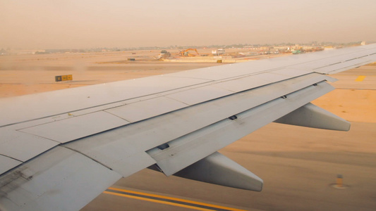 日出时班古里安机场跑道上的飞机机翼视频