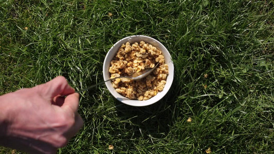 在绿草上的生态有机阳光夏日早餐人手将麦片紧缩麦片麦片视频