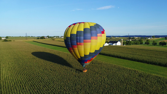 在夏日阳光明媚的日间一个热气球在农场视频