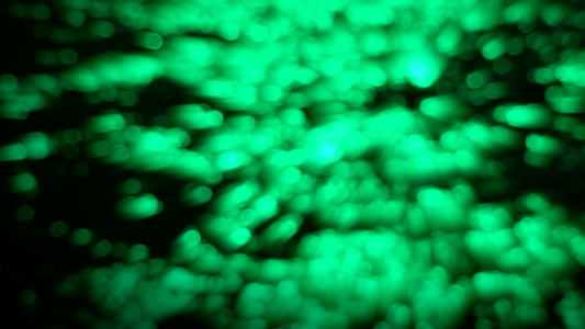 海水表面的绿光射线模糊和bokeh反光视频