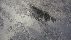 沥青上的泥坑加上雨滴8秒视频