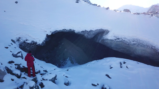 登山者看着冰洞的入口视频