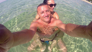 浪漫快乐情侣的自拍在松绿海滨水中放松暑假概念16秒视频