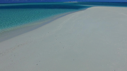 蓝色绿色海洋和接近冲浪的白色沙滩背景的海滨假日豪华视频