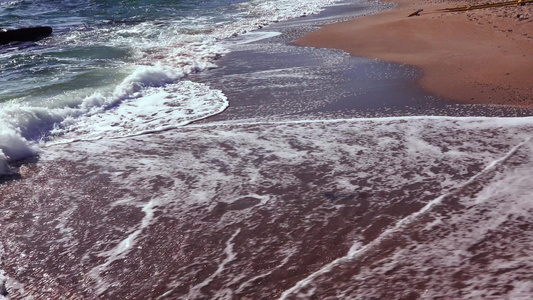 海浪沙滩上有白泡沫卷太阳在水中的反射黑海视频