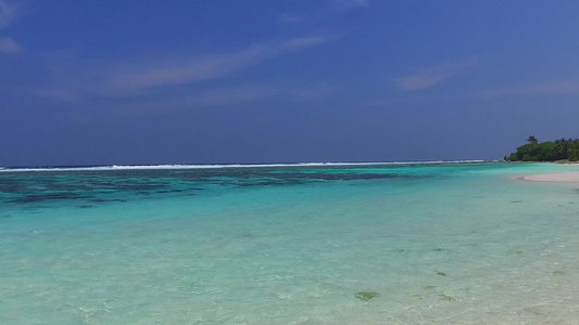 日落前以蓝色环礁湖和白色沙滩背景进行完美的海湾海滩视频