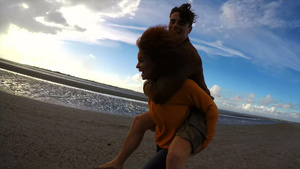 女人背着男人在沙滩上奔跑21秒视频