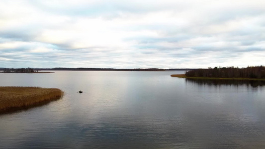 无人驾驶飞机飞越湖上渔民上空视频