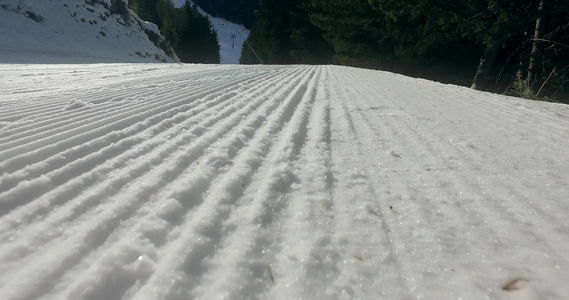 在滑雪坡上用雪机制成的雪雪线电影般的平坦拍摄视频