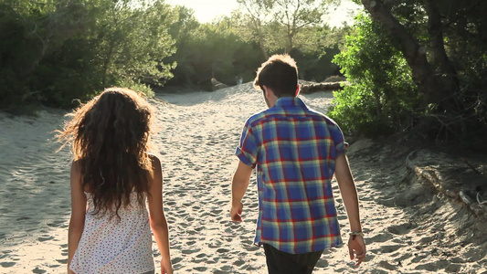 光脚走在沙子上的年轻夫妇视频