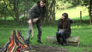 年轻夫妇坐在篝火旁的圆木上18秒视频