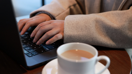 女青年在咖啡厅使用电脑打字视频