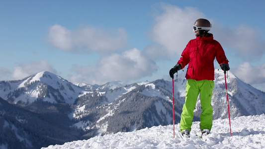 滑雪者用滑雪杆欣赏风景并指着山视频