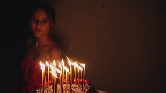 少女在庆祝生日时跳舞在巧克力蛋糕上点燃蜡烛视频