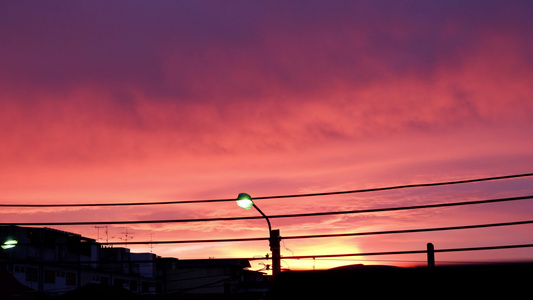日落时粉红色云彩和路灯视频