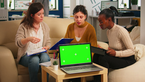 坐在桌边与绿色屏幕笔记本电脑讨论战略的多样化妇女21秒视频