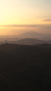 夕阳航拍山顶风力发电机新能源视频