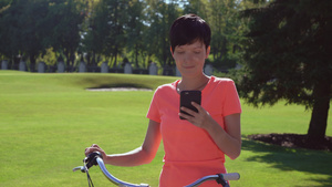 坐自行车上看手机的女人16秒视频