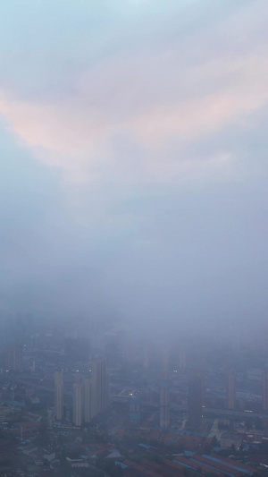 高空航拍云雾中的城市地标天际线商务中心高楼晚霞天空素材云雾素材64秒视频